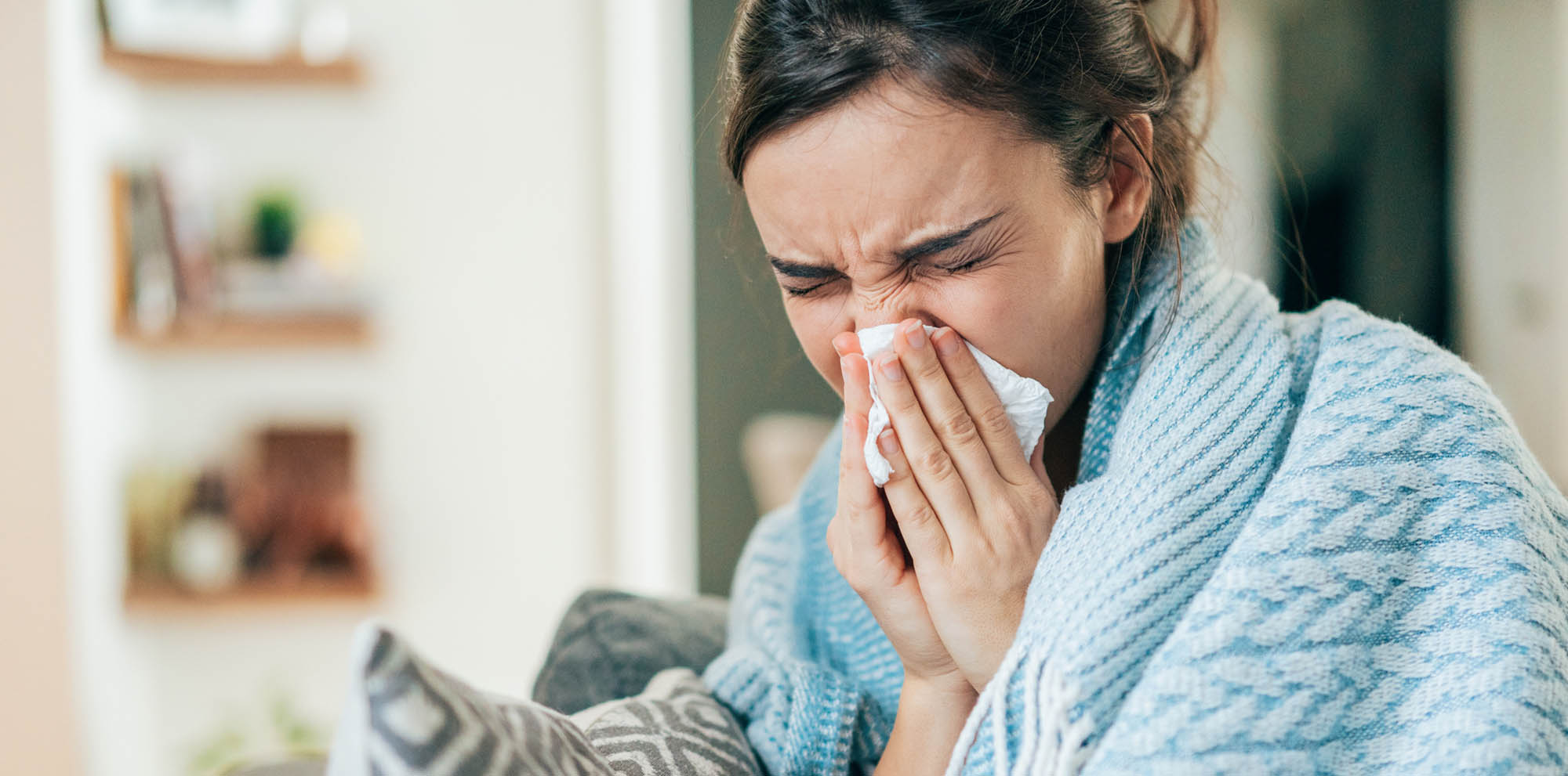Woman sneezing with sinus issues