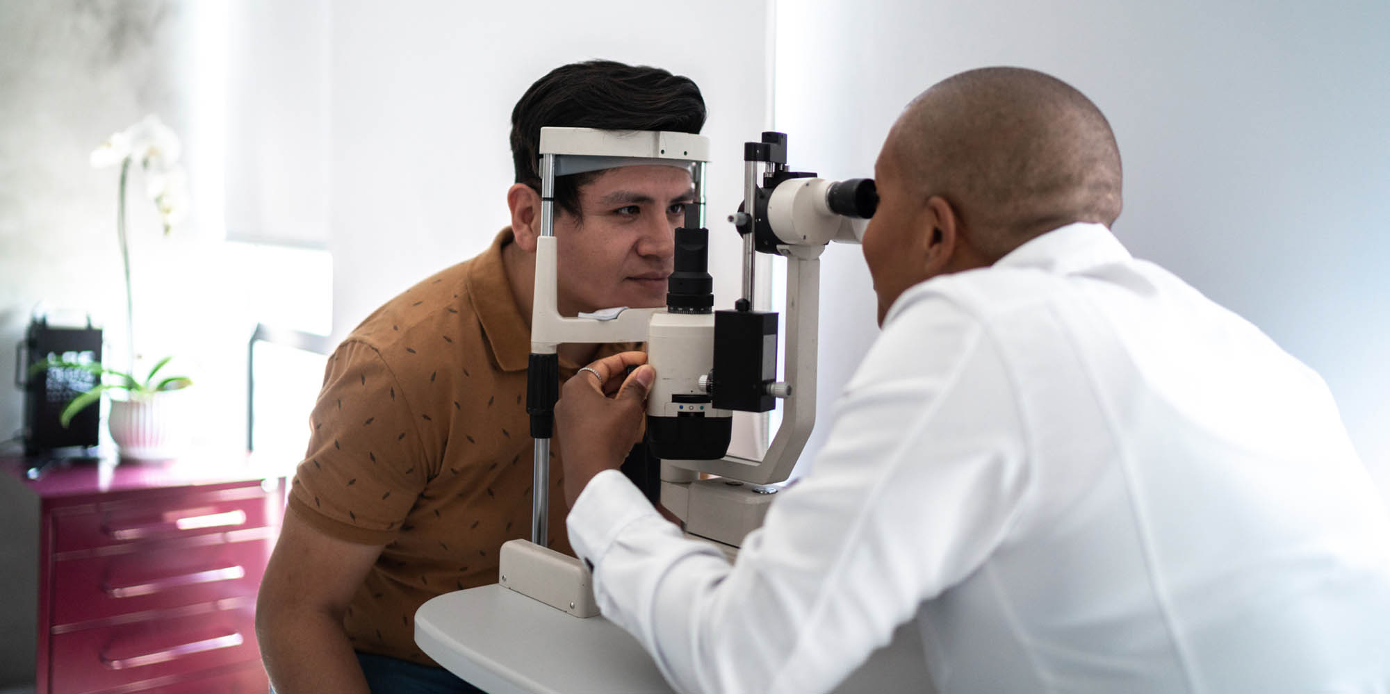 Physician giving eye exam