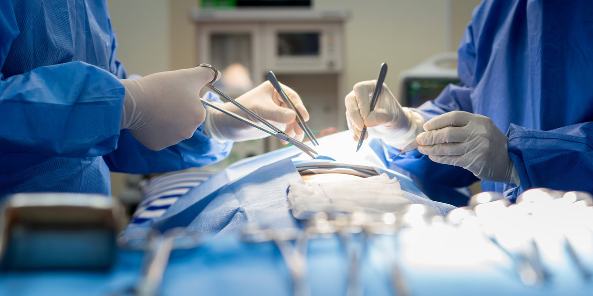 image of physicians performing a surgery