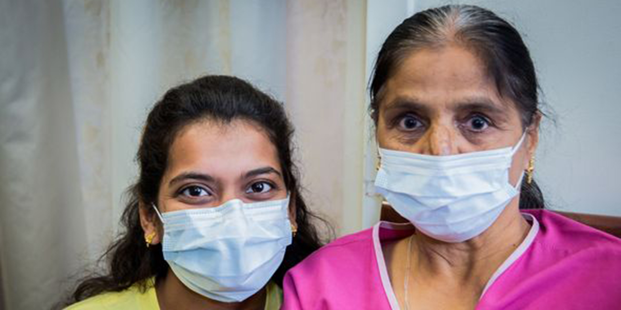 2 women wearing masks