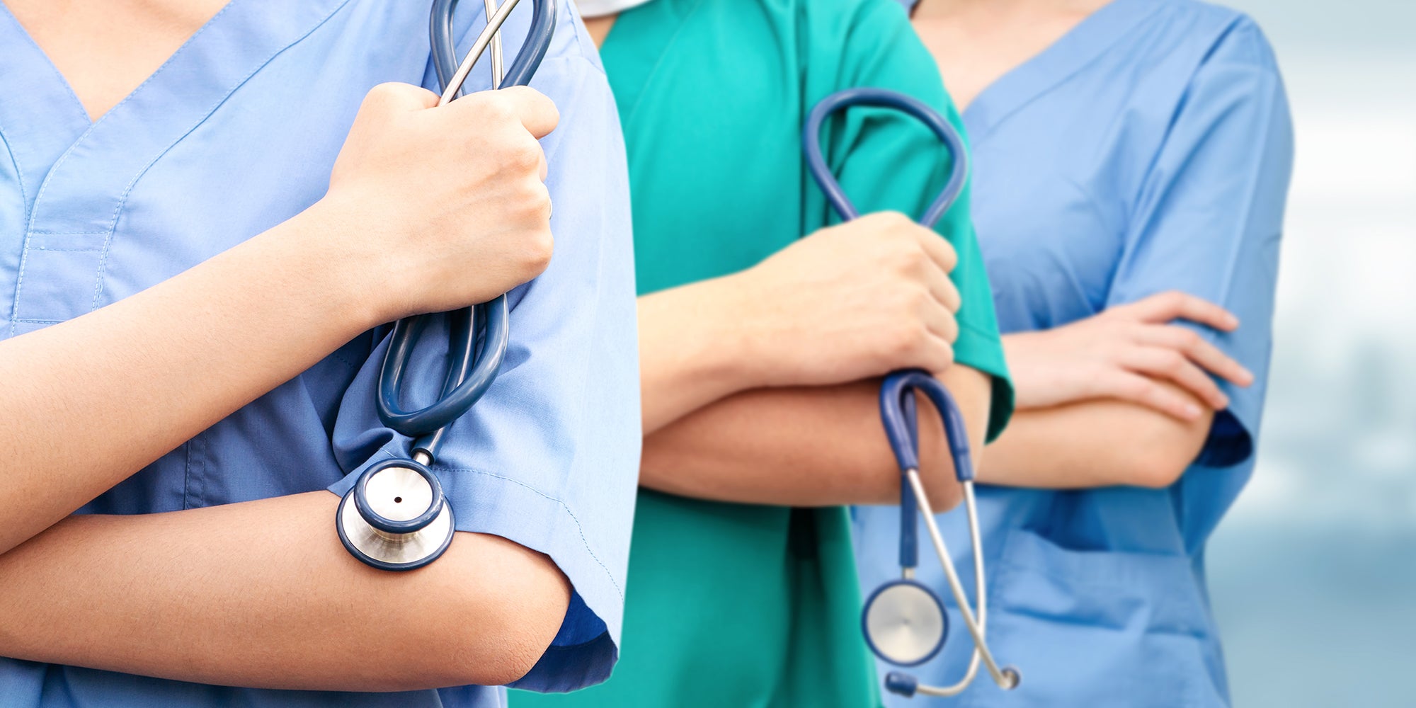 Three nurses folding arms