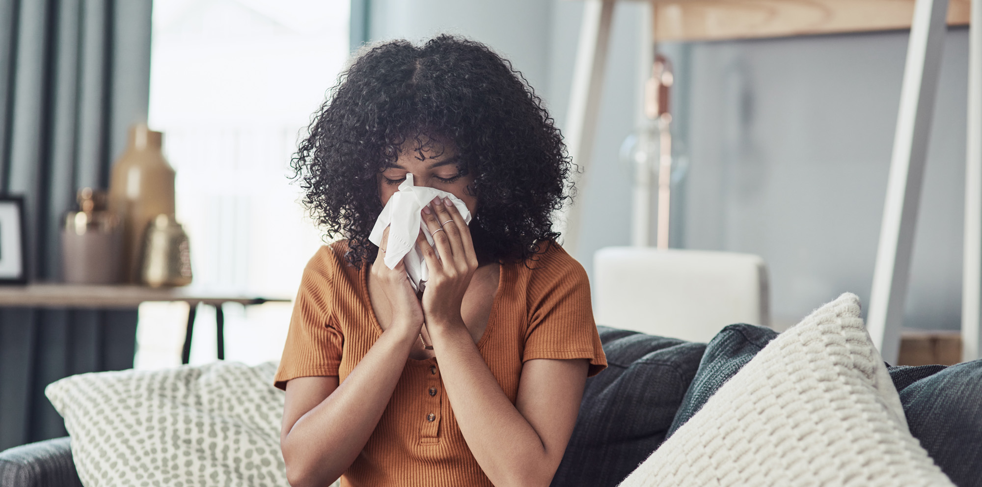 Woman blowing her nose