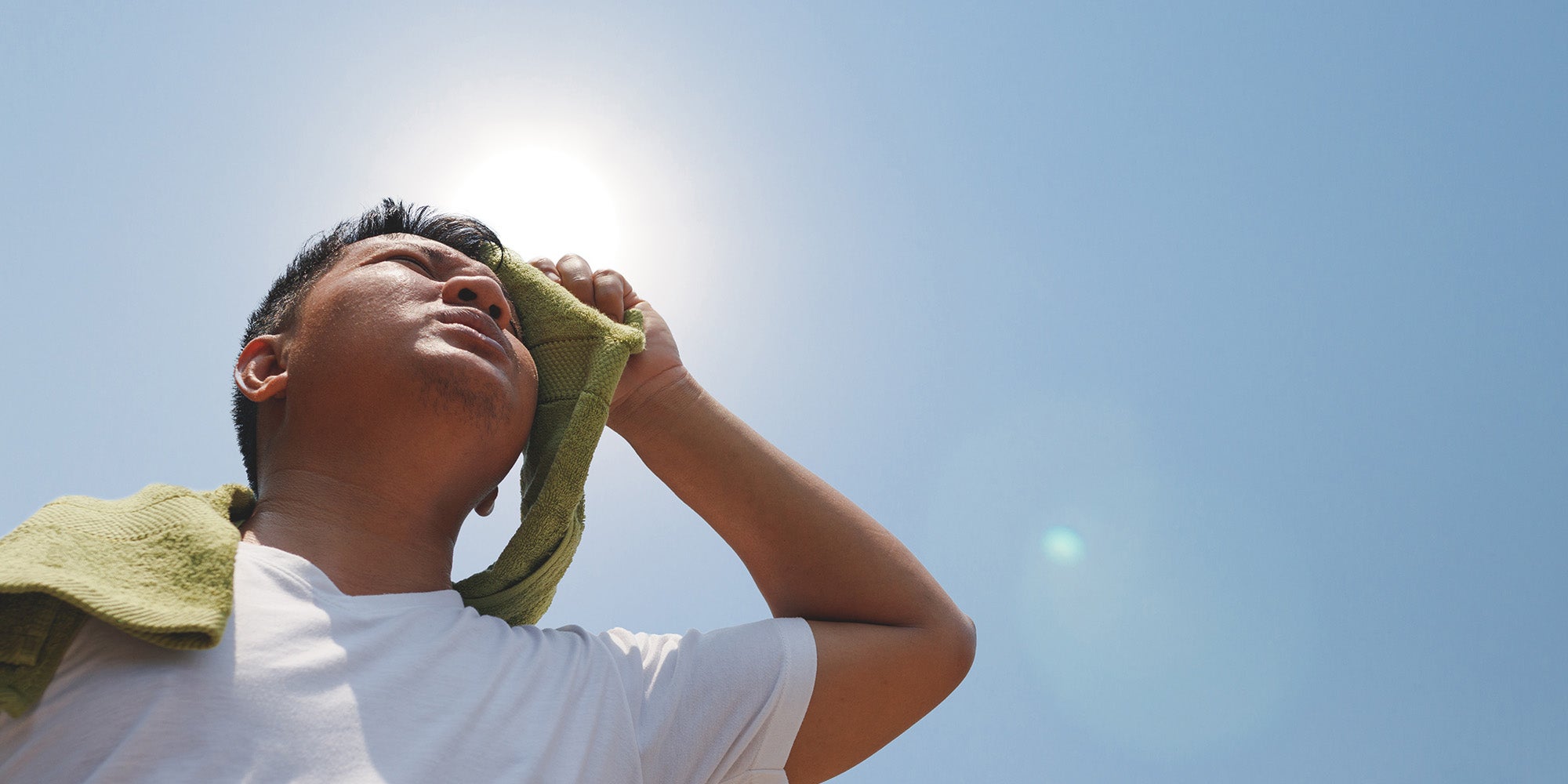 Man outside with towel on face