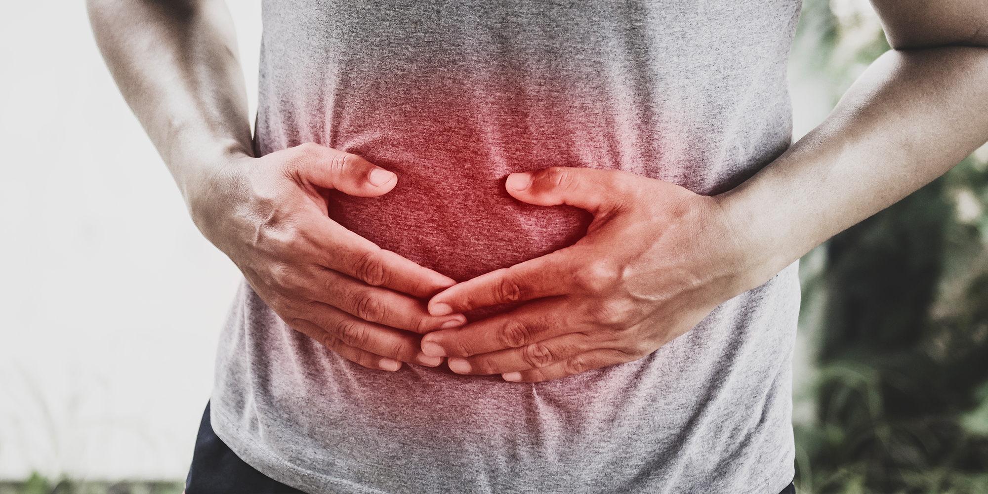 Man holding stomach in pain