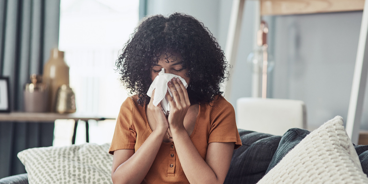 Woman blowing her nose