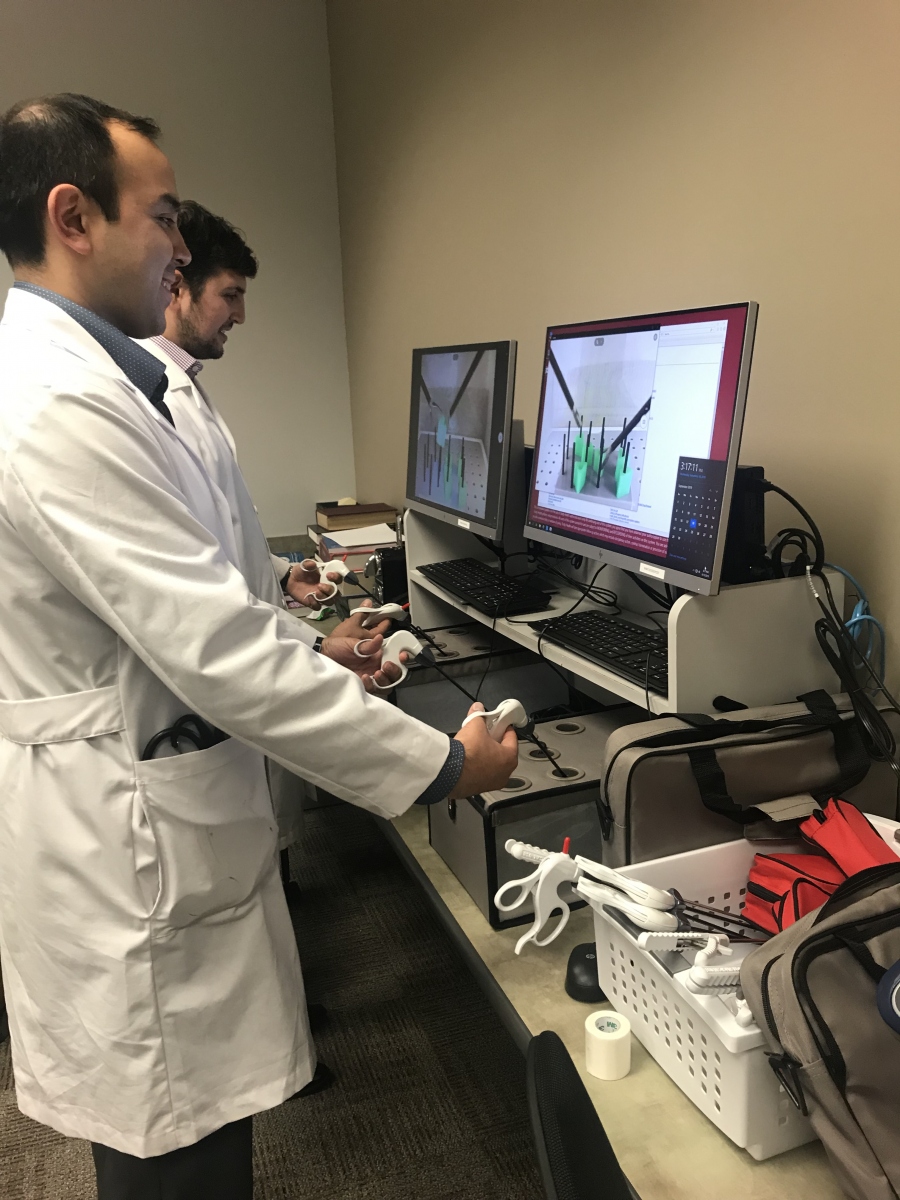 Residents working with high-technology surgery tools