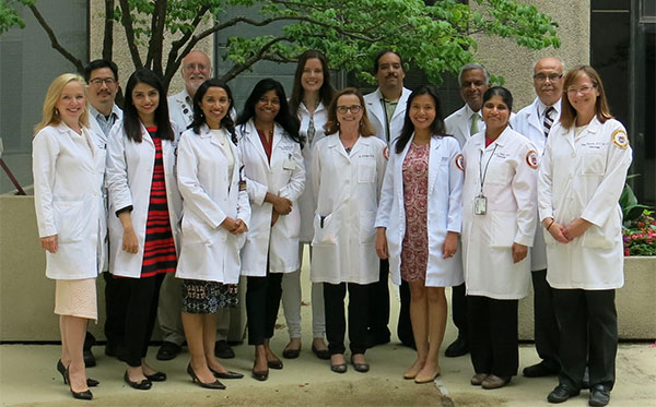 Fellows and faculty in lab coats